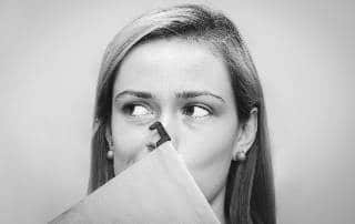 woman-using-file-to-cover-nose